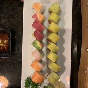 a person holding a plate of sushi