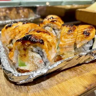 a variety of sushi on a wooden board