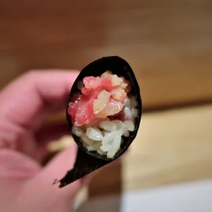 a hand holding a piece of food