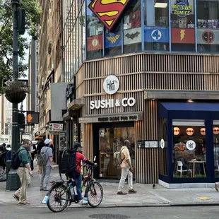 people walking and biking on a city street