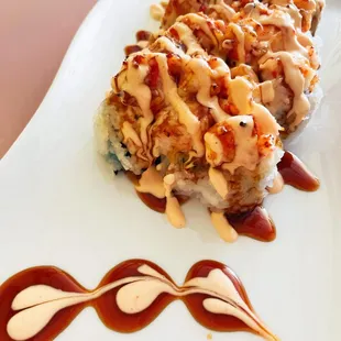 Baked lobster roll 
 Inside: crab, avocado 
 Outside: (baked) lobster mix, eel sauce, and spicy mayo