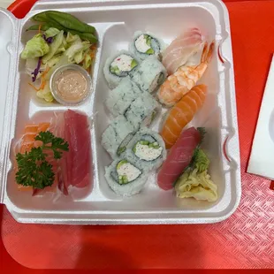 a tray of sushi and rolls