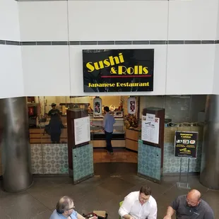people sitting at tables in a restaurant