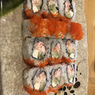 a plate of sushi and rolls