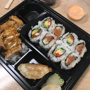 a tray of sushi and rolls