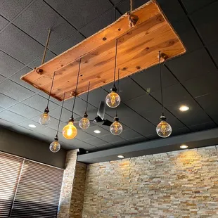 a restaurant with exposed ceilings and exposed lighting