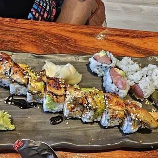 a plate of sushi on a wooden table