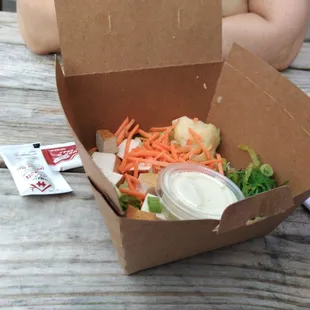 Poke bowl. This is how it appeared on opening. Les than half an inch of (cauliflower) rice in the bottom and a few toppings.