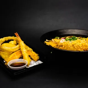 a plate of fried vegetables and a bowl of dipping sauce