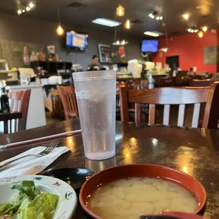 a bowl of soup and a plate of salad