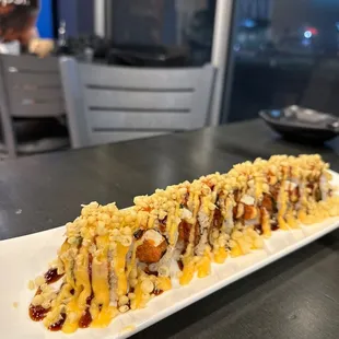 a long sushi roll on a white plate