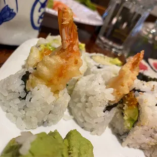 a plate of sushi and shrimp