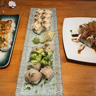 three plates of sushi on a table