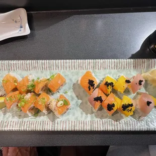 a plate of sushi and a bottle of wine