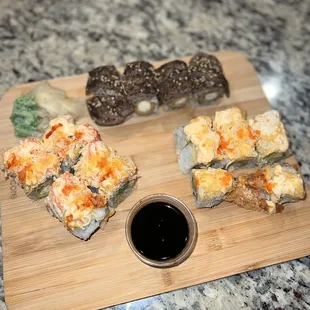 a variety of sushi on a cutting board