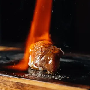 a piece of meat being cooked on a grill