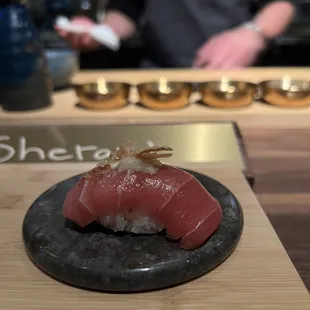 a sushi dish on a black plate