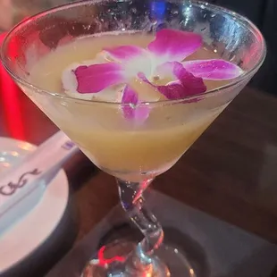 a martini with a flower in it