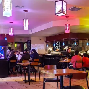 people sitting at tables in a restaurant