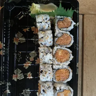 a plate of sushi with a lemon wedge