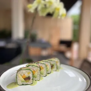 Happa 64 Roll with mango, shiitake, cucumber, takuan radish, and avocado, wrapped in collard greens