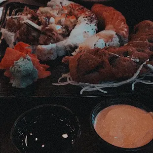 a plate of sushi and sauces