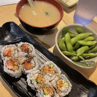 a bowl of soup and a plate of sushi