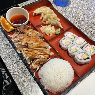 D30. Four Pieces California Rolls, Gyoza and Chicken Bento Box Dinner