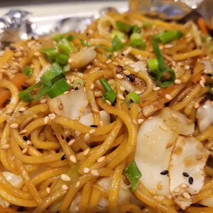 a plate of noodles with scallops and scallops