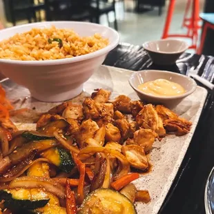 a platter of sushi bombs with a side of macaroni and cheese