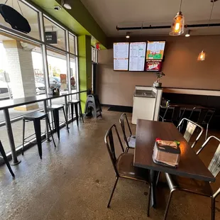 a dining area with tables and chairs
