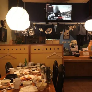 a dining room with a television in the background