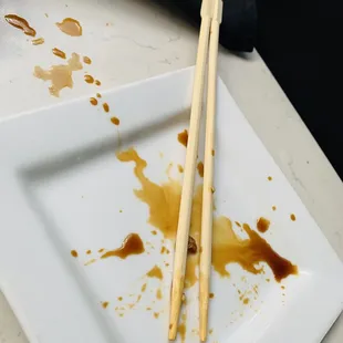 chopsticks and sauce on a plate
