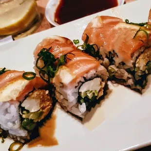 Sunshine Roll - salmon, spicy krab, cream cheese, avo, asparagus, scallions, sliced lemons, ponzu.