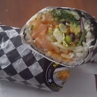 sushi roll  salmon, lettuce, edamame, onions, seaweed avocado, fish eggs, red cabbage.the sauce was poke