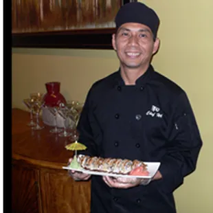 a man holding a plate of sushi