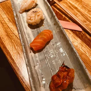 a long rectangular plate with sushi on it