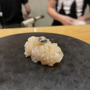 a sushi on a black plate