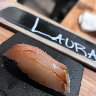  a sushi on a slate plate