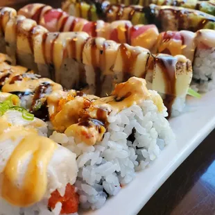 a long platter of sushi rolls