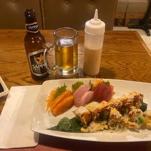 a plate of sushi and a bottle of beer