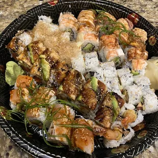 a plate of sushi on a granite countertop