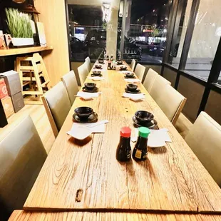 a long wooden table with plates on it