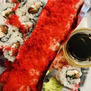 a plate of sushi and rolls
