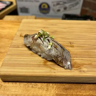 a piece of fish on a cutting board