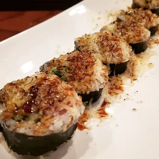Avalanche IV- eel, avocado, and jalapeño inside baked with mozzarella cheese on top!