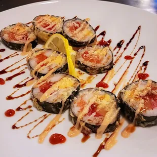 Moonlight- crab stick, salmon, tuna, and tamago inside and deep fried. Comes with eel sauce and yum yum sauce on top!