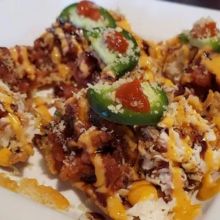Sushi taco- deep fried wonton skins with spicy tuna, homemade crab meat, jalapeño, eel sauce, and spicy mayo on top!