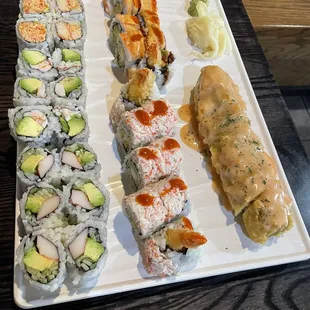 various types of sushi on a white plate