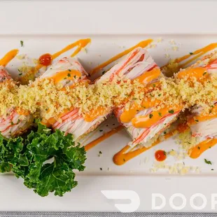 a plate of sushi with sauce and parsley